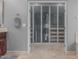 Bathroom featuring a towel rack and a closet with glass doors at 22166 N Lakeside Dr, Maricopa, AZ 85138