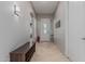Inviting foyer with tile flooring, a bench, and a decorative table at 22166 N Lakeside Dr, Maricopa, AZ 85138