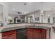 Open kitchen area with a breakfast bar, dark cabinets, and sleek countertops overlooking the living space at 22166 N Lakeside Dr, Maricopa, AZ 85138