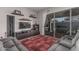 Bright living room with sectional sofa, TV, and access to the outdoor patio at 22166 N Lakeside Dr, Maricopa, AZ 85138