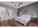Inviting bedroom with wood floors, ceiling fan, and neutral tones with en suite bathroom, creates a relaxing atmosphere at 22166 N Lakeside Dr, Maricopa, AZ 85138