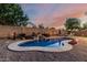 Picturesque pool area with decorative rock waterfall and mature trees and shrubs create a tranquil backyard for rest and rejuvenation at 22166 N Lakeside Dr, Maricopa, AZ 85138