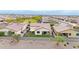Spacious aerial view of a landscaped backyard with a covered patio and dining area surrounded by desert landscaping at 22282 N 184Th Ln, Surprise, AZ 85387