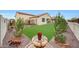 Lush backyard featuring a well-maintained lawn, desert landscaping, and a charming water feature at 22282 N 184Th Ln, Surprise, AZ 85387