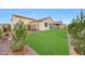 Well-maintained backyard featuring an expansive synthetic grass lawn and desert landscaping at 22282 N 184Th Ln, Surprise, AZ 85387