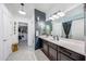 A well-lit bathroom featuring a spacious vanity, modern fixtures, and ample storage at 22282 N 184Th Ln, Surprise, AZ 85387