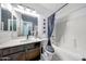 Clean bathroom with a shower-tub combo, vanity sink, and dark wood cabinets at 22282 N 184Th Ln, Surprise, AZ 85387