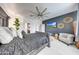 A primary bedroom featuring a ceiling fan, accent wall, and modern decor at 22282 N 184Th Ln, Surprise, AZ 85387