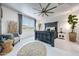 The bedroom features a large window, modern ceiling fan, and stylish furniture at 22282 N 184Th Ln, Surprise, AZ 85387