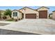Charming single-story home showcasing a three-car garage, landscaped yard, and desert accents at 22282 N 184Th Ln, Surprise, AZ 85387
