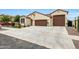 Well-maintained single-story home featuring a three-car garage and desert landscaping at 22282 N 184Th Ln, Surprise, AZ 85387