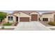 This home showcases a spacious three-car garage, desert-friendly landscaping, and well-maintained front yard at 22282 N 184Th Ln, Surprise, AZ 85387