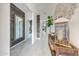 A well-lit hallway with modern decor and rustic accents, leading to various rooms in the home at 22282 N 184Th Ln, Surprise, AZ 85387