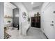 Charming hallway with decoratives, a bench, storage cabinet, and access to a half-bathroom at 22282 N 184Th Ln, Surprise, AZ 85387