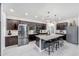 Modern kitchen featuring dark wood cabinetry, stainless steel appliances, and a central island at 22282 N 184Th Ln, Surprise, AZ 85387