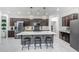 A kitchen with dark brown cabinets, a stainless steel refrigerator, and a central island with seating at 22282 N 184Th Ln, Surprise, AZ 85387