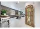 Open-concept living space with a dining table, wood accent wall, and stylish furnishings at 22282 N 184Th Ln, Surprise, AZ 85387