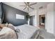 A beautiful bedroom features an accent wall, a decorative ceiling fan, and natural light at 22282 N 184Th Ln, Surprise, AZ 85387