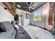 Office featuring a grey sofa, a light-toned floor rug, a ceiling fan, and natural light at 22282 N 184Th Ln, Surprise, AZ 85387