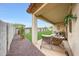 Covered patio offering comfortable seating and a view of the serene backyard oasis at 22282 N 184Th Ln, Surprise, AZ 85387