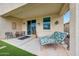 This covered patio features comfortable seating and creates an inviting outdoor living space with a garden view at 22282 N 184Th Ln, Surprise, AZ 85387