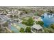 Beautiful aerial view of the community featuring a lake, park, basketball court, and well-maintained landscaping at 22683 N Aaron Rd, Maricopa, AZ 85138