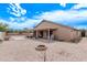 Expansive backyard featuring a covered patio, low maintenance gravel, and mature landscaping at 22683 N Aaron Rd, Maricopa, AZ 85138