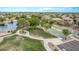 Aerial view of a basketball court adjacent to a lake and park area, enhancing the community's recreational amenities at 22683 N Aaron Rd, Maricopa, AZ 85138