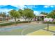 Community park features a basketball court and playground near a lake, enhancing an active lifestyle at 22683 N Aaron Rd, Maricopa, AZ 85138