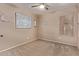 Bedroom featuring coastal décor, a window, and neutral walls at 22683 N Aaron Rd, Maricopa, AZ 85138