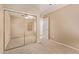 Bedroom featuring mirrored closet doors, tan carpet, and neutral walls at 22683 N Aaron Rd, Maricopa, AZ 85138