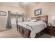 Comfortable bedroom featuring neutral decor, carpet flooring, and a large window at 22683 N Aaron Rd, Maricopa, AZ 85138