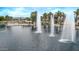 Scenic view of the community lake with fountains and a charming park gazebo, ideal for relaxation at 22683 N Aaron Rd, Maricopa, AZ 85138