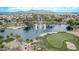 Beautiful community lake with fountains, golf course, and lush landscaping providing a serene and active lifestyle at 22683 N Aaron Rd, Maricopa, AZ 85138