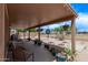 A spacious covered patio features string lights, hanging plants, and comfortable seating at 22683 N Aaron Rd, Maricopa, AZ 85138