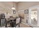 Cozy dining area featuring a glass table, and an adjacent door to the backyard at 22683 N Aaron Rd, Maricopa, AZ 85138