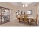 Well-lit dining area with tile floors and views of the adjacent kitchen at 22683 N Aaron Rd, Maricopa, AZ 85138