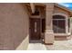 Inviting front entryway featuring a decorative wood door, textured walls and tiled walkway at 22683 N Aaron Rd, Maricopa, AZ 85138