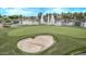 Scenic golf course view with a large sand trap, fountains, and lush greens perfect for recreational enjoyment at 22683 N Aaron Rd, Maricopa, AZ 85138