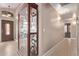 Bright entryway featuring tile floors, display case, and neutral paint, with views of the front door at 22683 N Aaron Rd, Maricopa, AZ 85138