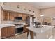 Well-equipped kitchen featuring stainless steel appliances, granite counters, and ample cabinet space at 22683 N Aaron Rd, Maricopa, AZ 85138
