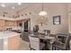 Charming kitchen showcasing stainless steel appliances, an island, and a dining area at 22683 N Aaron Rd, Maricopa, AZ 85138