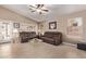 Comfortable living room with tile flooring, ceiling fan, and plenty of natural light at 22683 N Aaron Rd, Maricopa, AZ 85138