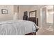 Cozy main bedroom featuring a dark wood dresser, a TV, and an ensuite bathroom at 22683 N Aaron Rd, Maricopa, AZ 85138