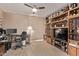 Functional office area featuring wood-look floors, built-in shelving, and a dedicated workspace at 22683 N Aaron Rd, Maricopa, AZ 85138