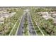 Scenic aerial view of a palm tree-lined street leading to a tranquil lake in a beautiful community at 22683 N Aaron Rd, Maricopa, AZ 85138