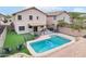 Aerial view of the backyard featuring a pool, grass, covered patio, and fenced yard at 2306 E Parkside Ln, Phoenix, AZ 85024