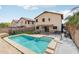 Backyard view showcasing a pool, covered patio, and fenced yard at 2306 E Parkside Ln, Phoenix, AZ 85024