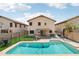 Home's backyard features a pool, grass, covered patio, and fenced yard at 2306 E Parkside Ln, Phoenix, AZ 85024