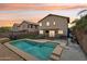 Backyard view showcasing a pool, covered patio, and fenced yard at sunset at 2306 E Parkside Ln, Phoenix, AZ 85024